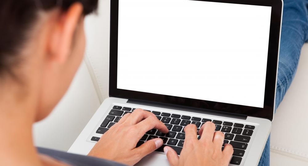 woman-sitting-down-typing-on-computer